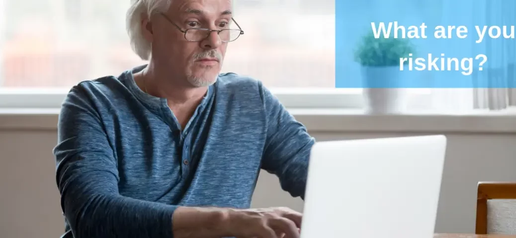 older man typing on laptop