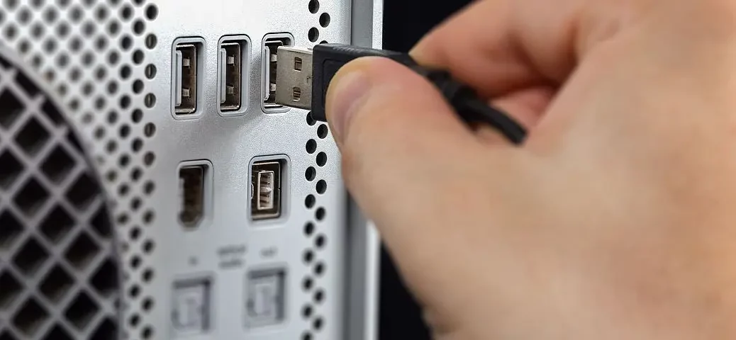 person-inserting-usb-cable-on-usb-port