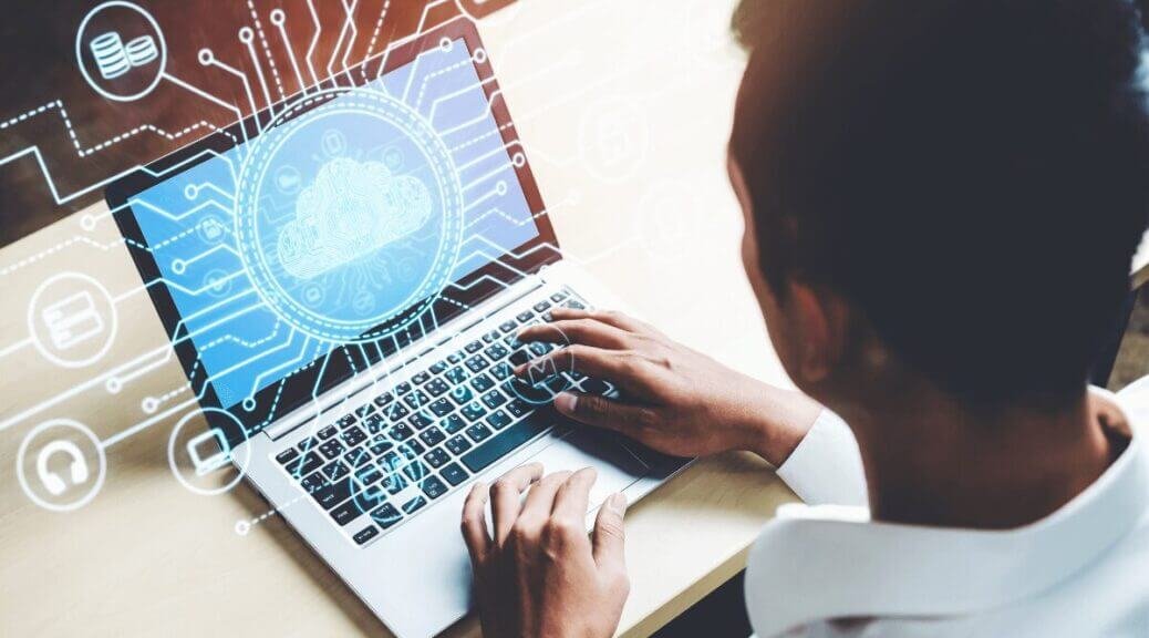 man typing on laptop