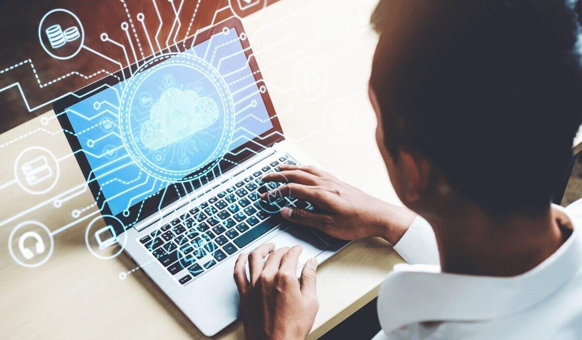 man typing on laptop