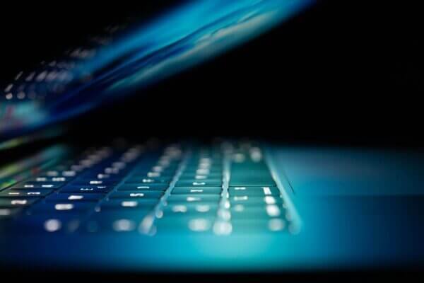 closeup photo of a laptop keyboard in the dark