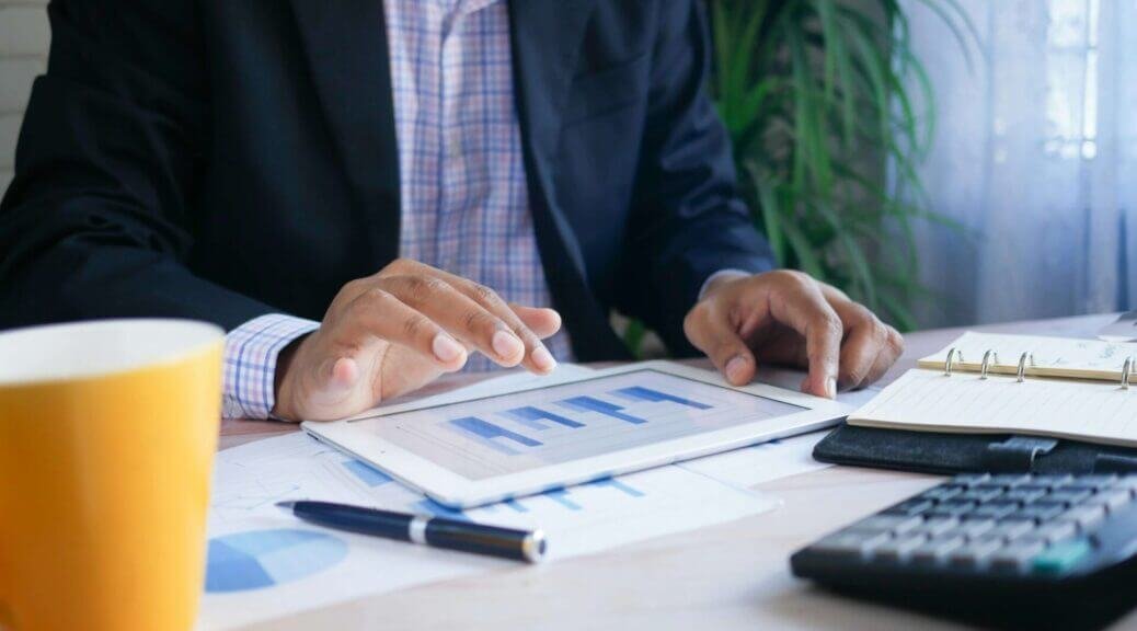 businessman looking at graphs on a tablet