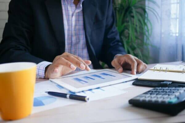 businessman looking at graphs on a tablet