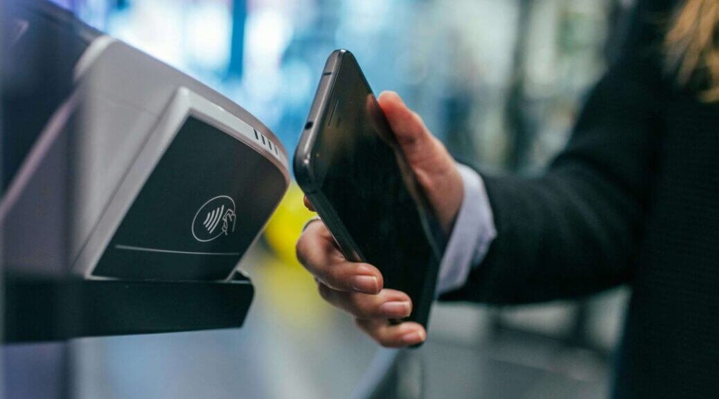 woman making a contactless payment with phone