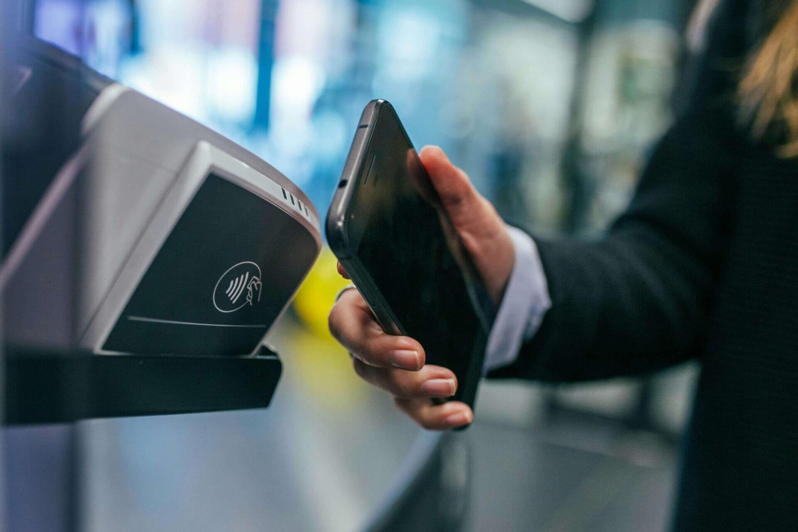 woman making a contactless payment with phone