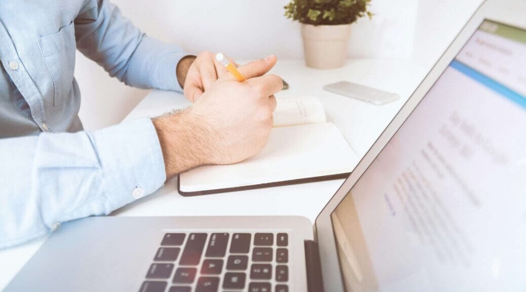 a man writing something in his notebook